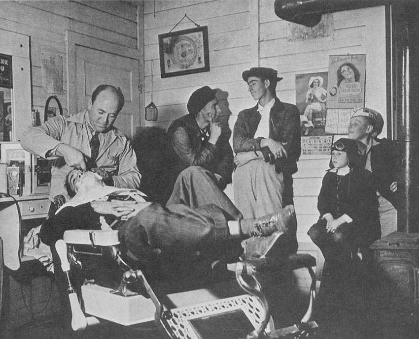 Mr. Aiden (Shorty) Brownlee's Barber Shop, (Standing in back) Max Coats and ____ Ishee, (Children sitting) Raymond Wade, and "Scooter Boot" Wade