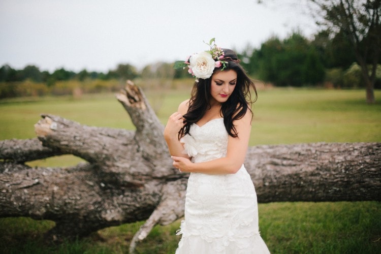 Outdoor bridal portrait with fallen tree and bride with floral wreath by Starling & Sage, Hattiesburg Wedding Photographers