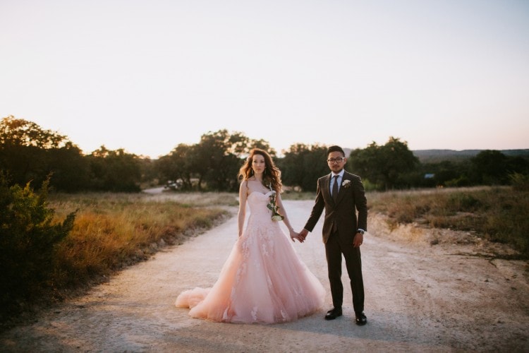 Bride and groom portrait on dirt road at sunset, blush pink wedding gown, by Starling & Sage, Hattiesburg MS vintage wedding photographers