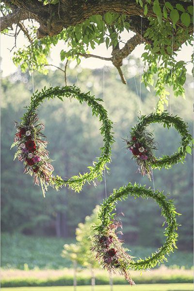 Hanging greenery wreaths as outdoor wedding decor!