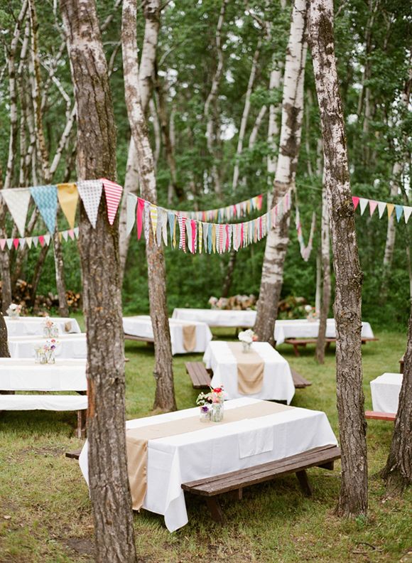 Love the pennants hung throughout the picnic tables. Easy and affordable decor for an outdoor wedding reception!